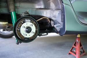 Close up bearing of real wheel on the city car service concept in the shop and jack up level car photo