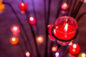 Close up Aroma Purple candles colorful in blur background for background and texture photo