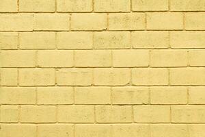 Light yellow color brick wall close up image row brick and cement block background and texture photo