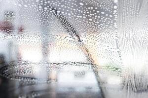 Bubble on the glass The windshield wipers  of car wash and cleaning in gas station  car wash concept photo