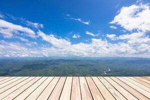 Empty top wooden board table and view of mountain and blue sky use for product display and background and copy space photo