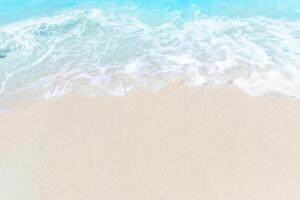Sea wave and bubble on a sandy white beach blue sea background texture and copy space holiday concept photo