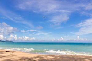 Summer concept Sea view sand beach with wave blue sky and The plane is rising nature view at Phuket tourist attraction beach Thailand photo