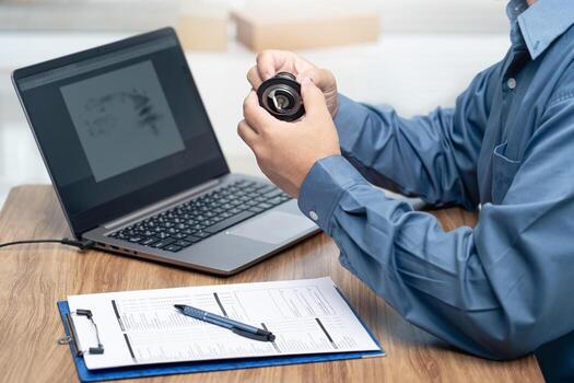 Hand a man hold car thermostat of engine use laptop computer check new part in stock compare and check auto parts for accuracy before replacing in periodic maintenance in the car service center photo