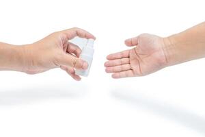 A man send alcohol spray For another man use cleaning your hand with protection concept in white background photo