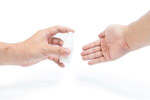 Hand a man use alcohol spray cleaning your hand with protection concept in white background photo