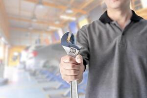 Technician hands with mechanic holding a wrench in service shop service concept of automobile photo