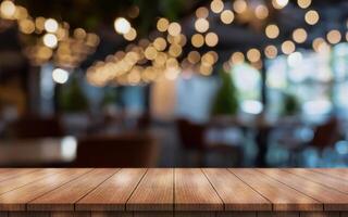 Empty wooden table top with lights bokeh on blur restaurant background photo