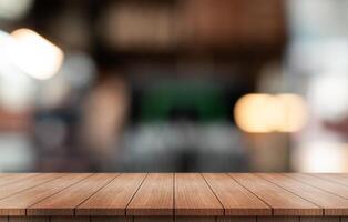 Empty wooden table top with lights bokeh on blur restaurant background. photo