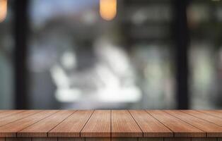 Empty wooden table top with lights bokeh on blur restaurant background. photo