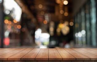 Empty wooden table top with lights bokeh on blur restaurant background. photo
