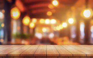 Empty wooden table top with lights bokeh on blur restaurant background photo