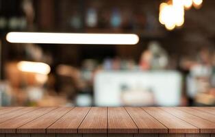 Empty wooden table top with lights bokeh on blur restaurant background. photo