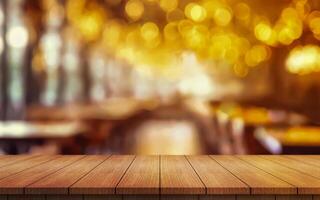 Empty wooden table top with lights bokeh on blur restaurant background photo