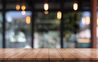Empty wooden table top with lights bokeh on blur restaurant background. photo