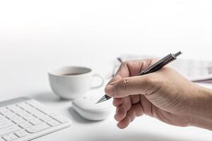 Hand a man holding a pencil and use computer desktop in business concept photo