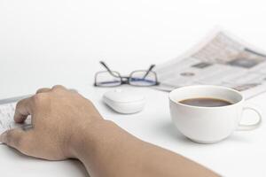 A man typing on keyboard with computer desktop in business concept and glasses coffee cup in background photo