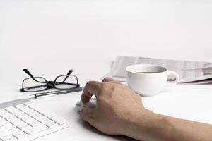 A man use mouse and keyboard of computer desktop and glasses coffee document in blur background photo