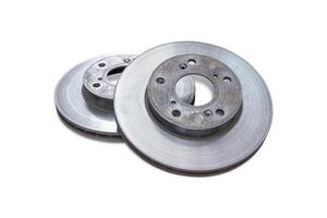 Old disk brake of car with rust and wear and tear from use on the white background photo