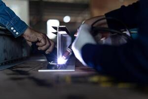 Close up hand welder mix welding steel work in factory photo