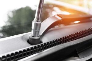 Close up Block wrench On the wipers of car Technician remove and adjust concept for nut lock photo