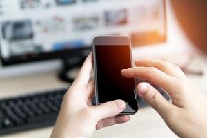 Women search music file in smartphone and connecting with computer and transfer data photo