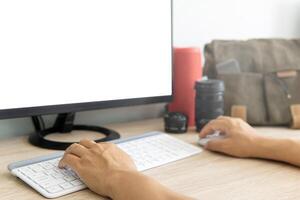 Photographer using a computer process and make photo form digital camera of holiday trip and camera equipment in background