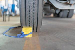 Temporary Stopper of truck wheel prevent the vehicle from moving of parking for safety in transportation work photo