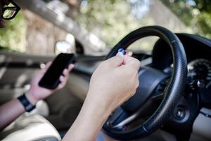 Close up ear phone in hand a man connect to smartphone use for  hand free with drive a car safety transport concept and inside car background photo