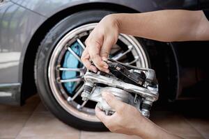 A man remove brake pad from spare caliper part in service action concept brake system of car photo