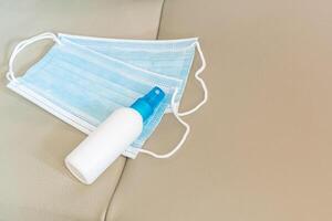 Alcohol spray and mask are placed on the car seat basic antivirus protection equipment In car use everyday photo