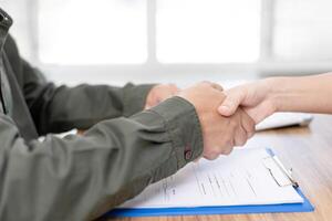 Insurance concept Business man shake hands with women after photo