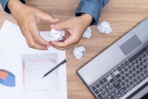 A man crunching papers in hand  strain feeling was frustrated with working failed with document in work office photo