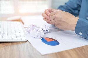 A man crunching papers in hand  strain feeling was frustrated with working failed with document in work office photo