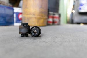 Old Rubber bush and joint component part of car suspension on service shop floor change and maintenance in service process photo