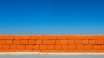 AI generated Vibrant Orange Brick Wall Against Clear Blue Sky photo