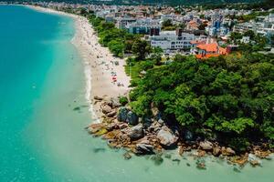 Holiday beach with resort town and turquoise ocean in Brazil. Aerial view photo