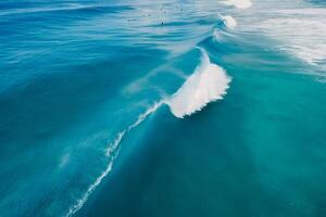 Blue wave in tropical ocean. Breaking barrel wave. Aerial view photo