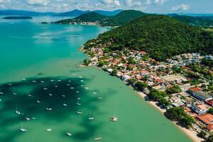 Coastline in Santo Antonio de Lisboa with sailing boats in sea in Brazil. Aerial view. photo