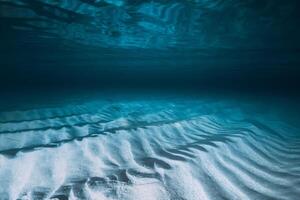Tropical transparent blue ocean with sandy bottom. Panoramic underwater view with artificial light photo