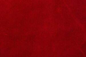 Red suede texture. Natural red dyed leather, suede macro photo. photo