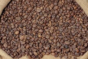 Coffee beans in a bag. Roasted aromatic natural coffee macro photo. photo