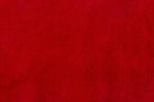 Red suede texture. Natural red dyed leather, suede macro photo. photo