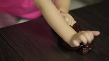 Child hands having fun with brown slime. Kid playing with hand made toy slime video