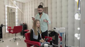 Professional hairdresser styling combing model hair. Making volume hairstyle video