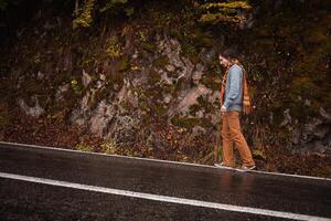 lonely man on road, concept of loneliness, depression, thoughtfulness. Autumn, mountains, beautiful background. Abstraction path to oneself, feeling of soul, misunderstanding photo