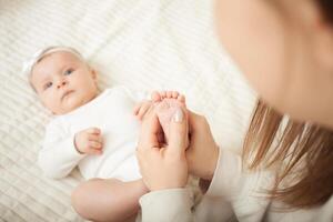 mother plays with newborn baby photo