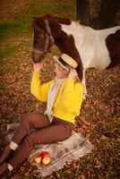 hermosa imagen, otoño naturaleza, mujer y caballo, concepto de amar, amistad y cuidado. antecedentes. tartán. foto