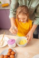 Mother and daughter cook pie in purple kitchen, training and development, interesting game and help. Happy family together. beats eggs. photo