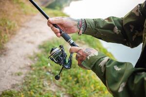 pensioner collects a fishing rod. Instruction, collection process. Copy space, senior concept. Outdoor, beautiful scenery. spool photo